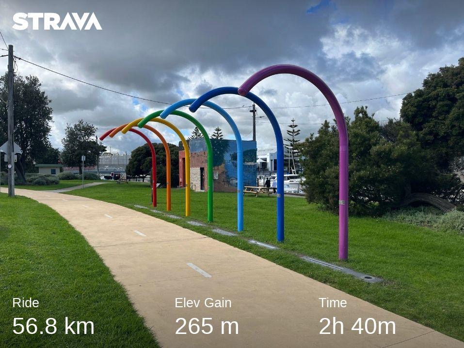 Statistics from a Strava ride overlaid on a sculpture of arched rainbow pipes, 56.8km in 2 hours 40 minutes